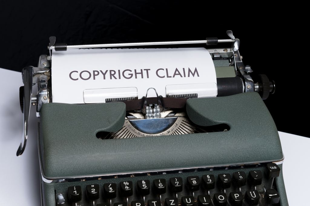 Photo of a typewriter with a piece of paper with the words copyright claim.
Image sourced via Unsplash.
