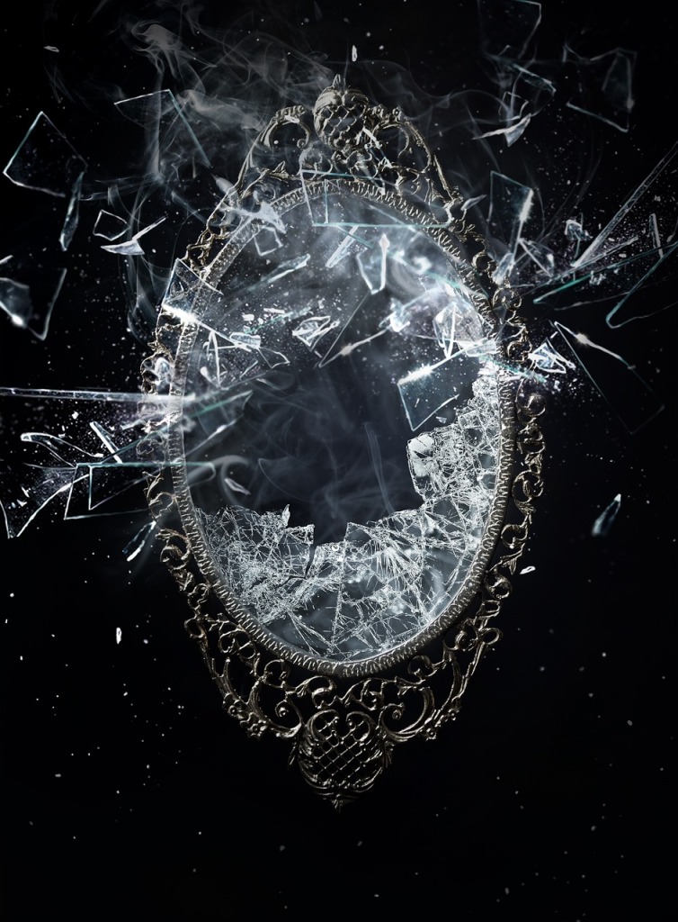 Photo of an ornately framed mirror being shattered on a black background.
Image by creatifrankenstein from Pixabay. 